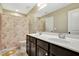 Bathroom featuring double sinks, dark cabinets, and decorative shower curtain at 4405 Aubaun Way, Knightdale, NC 27545