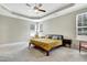 Spacious main bedroom featuring tray ceilings, a ceiling fan, and ample natural light at 4405 Aubaun Way, Knightdale, NC 27545
