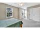 Bedroom with neutral walls, ceiling fan and natural light from windows at 4405 Aubaun Way, Knightdale, NC 27545