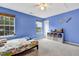 Blue bedroom with ceiling fan, natural light, and built in bookcase at 4405 Aubaun Way, Knightdale, NC 27545