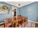 Elegant dining area featuring a long wooden table, stylish light, and sophisticated decor at 4405 Aubaun Way, Knightdale, NC 27545