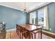 Bright dining room with a large table, unique light fixture, and a view of the outdoors at 4405 Aubaun Way, Knightdale, NC 27545