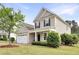 Inviting home exterior with a manicured lawn, tidy shrubbery, and a two-car garage at 4405 Aubaun Way, Knightdale, NC 27545