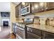 Close-up of a well-equipped kitchen featuring stainless steel appliances and granite countertops at 4405 Aubaun Way, Knightdale, NC 27545