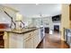 Bright, modern kitchen with granite island, stainless appliances, flowing into a cozy living space at 4405 Aubaun Way, Knightdale, NC 27545