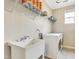 Practical laundry room featuring a utility sink, modern washer and dryer, and ample storage shelving at 4405 Aubaun Way, Knightdale, NC 27545