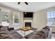 Inviting living room featuring a fireplace with stone accents and a rustic wooden coffee table at 4405 Aubaun Way, Knightdale, NC 27545