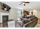 Cozy living room with a fireplace, comfortable sectional sofa, and views into the kitchen at 4405 Aubaun Way, Knightdale, NC 27545