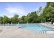 Community pool surrounded by lounge chairs and lush greenery, perfect for relaxing and enjoying the outdoors at 4405 Aubaun Way, Knightdale, NC 27545