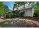 Exterior view of a home with a screened-in porch, surrounded by lush greenery, trees, and well-maintained lawn at 4900 Old Millcrest Ct, Raleigh, NC 27609