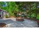 Inviting backyard with a brick fire pit and mature trees, ideal for outdoor entertaining at 4900 Old Millcrest Ct, Raleigh, NC 27609