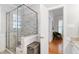 Modern bathroom with glass-enclosed shower and neutral tile, well lit at 4900 Old Millcrest Ct, Raleigh, NC 27609