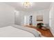 Cozy bedroom with hardwood floors, white walls, crown molding, and closet in the ensuite at 4900 Old Millcrest Ct, Raleigh, NC 27609