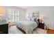 Comfortable bedroom with window shutters, soft rug, and stylish bedside tables at 4900 Old Millcrest Ct, Raleigh, NC 27609