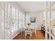 Eat-in kitchen with hardwood floors, shuttered windows, breakfast table, and white accents at 4900 Old Millcrest Ct, Raleigh, NC 27609