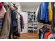 Walk-in closet featuring custom shelving, providing ample storage for clothes, shoes, and accessories at 4900 Old Millcrest Ct, Raleigh, NC 27609