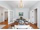 Elegant dining room featuring table set for dinner with chandelier and access to other rooms at 4900 Old Millcrest Ct, Raleigh, NC 27609
