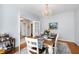 Elegant dining room with hardwood floors, a chandelier, and a beautifully set table at 4900 Old Millcrest Ct, Raleigh, NC 27609