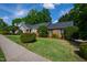 Charming single-story brick home with manicured lawn, mature trees, and a traditional architectural style at 4900 Old Millcrest Ct, Raleigh, NC 27609