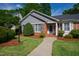Welcoming front entry with brick accents, manicured landscaping, and a neatly kept walkway, offering curb appeal at 4900 Old Millcrest Ct, Raleigh, NC 27609