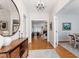 Entry Hallway with wood floors leading to open living spaces, enhanced by natural light at 4900 Old Millcrest Ct, Raleigh, NC 27609