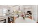 Bright kitchen with granite countertops, a center island, and breakfast nook with hardwood floors and living room view at 4900 Old Millcrest Ct, Raleigh, NC 27609