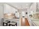 Kitchen featuring granite countertops, double sink, hardwood floors, white cabinets, and stainless steel appliances at 4900 Old Millcrest Ct, Raleigh, NC 27609
