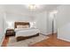 Spacious main bedroom with hardwood floors, natural light, and neutral decor at 4900 Old Millcrest Ct, Raleigh, NC 27609