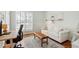 Bright home office with modern desk, shelving, and a comfortable sitting area at 4900 Old Millcrest Ct, Raleigh, NC 27609