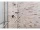 Shower featuring tiled walls, glass door, chrome fixtures, and a handheld shower head at 4900 Old Millcrest Ct, Raleigh, NC 27609