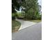 View of the home's exterior and long driveway leading to a cozy cabin surrounded by a lush green forest at 5601 Plum Nearly Ct, Raleigh, NC 27610