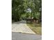 Cozy wood cabin with a beautiful, long driveway surrounded by mature trees creating a private and serene setting at 5601 Plum Nearly Ct, Raleigh, NC 27610