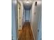 Hallway with hardwood floors and white door frames at 5601 Plum Nearly Ct, Raleigh, NC 27610