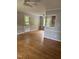 Bright living room featuring hardwood floors, neutral paint, and a ceiling fan that provides comfort and style at 5601 Plum Nearly Ct, Raleigh, NC 27610