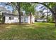 Spacious backyard and the exterior home featuring siding, and mature trees at 5802 Newhall Rd, Durham, NC 27713