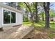 Backyard featuring a concrete patio, siding, and mature trees at 5802 Newhall Rd, Durham, NC 27713