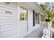Close-up of the front entrance showcasing a white door, siding, and black shutters at 5802 Newhall Rd, Durham, NC 27713