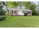 Charming single-story brick home with a well-maintained lawn and classic black shutters at 5802 Newhall Rd, Durham, NC 27713