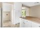 The laundry room featuring white cabinets with access to the back yard at 5802 Newhall Rd, Durham, NC 27713