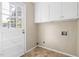 Laundry room featuring overhead storage and access to the backyard at 5802 Newhall Rd, Durham, NC 27713