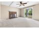 Living room with a brick fireplace, ceiling fan, and sliding glass doors to the outside at 5802 Newhall Rd, Durham, NC 27713