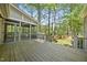 Spacious wooden back deck leading to a screened-in porch overlooking the private backyard at 6000 Canadero Dr, Raleigh, NC 27612