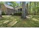 Brick home with a screened porch, wooden deck, and a large, private backyard with mature trees at 6000 Canadero Dr, Raleigh, NC 27612