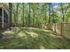 Wide view of a home with a large, fenced-in backyard and mature trees at 6000 Canadero Dr, Raleigh, NC 27612