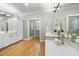 This bathroom features a double sink, a vanity, a standing shower, and wooden floors at 6000 Canadero Dr, Raleigh, NC 27612