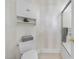 Cozy bathroom with a toilet, storage cabinet, and a glass-enclosed shower at 6000 Canadero Dr, Raleigh, NC 27612