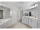 Bright bathroom featuring double sinks, tile floors, and a large mirror at 6000 Canadero Dr, Raleigh, NC 27612