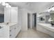 Well-lit bathroom with a large vanity, tile floors, and views into other bathrooms at 6000 Canadero Dr, Raleigh, NC 27612