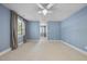 Spacious bedroom with light blue walls, neutral carpet, and a ceiling fan at 6000 Canadero Dr, Raleigh, NC 27612
