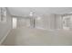 Bright bonus room with neutral carpet, ceiling fan, and multiple entrances offers flexibility and comfort at 6000 Canadero Dr, Raleigh, NC 27612
